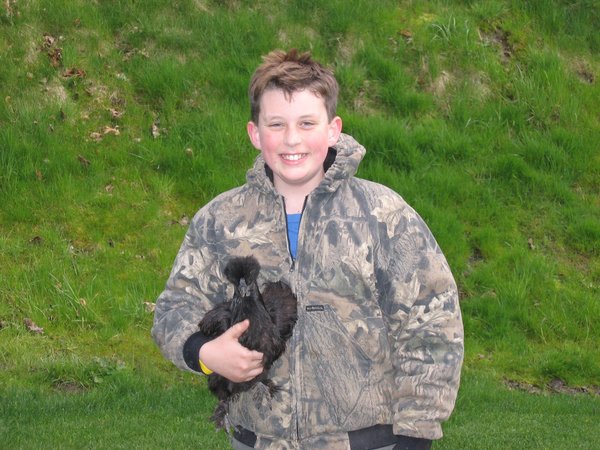 Cody holding a black Silkie chicken in second grade